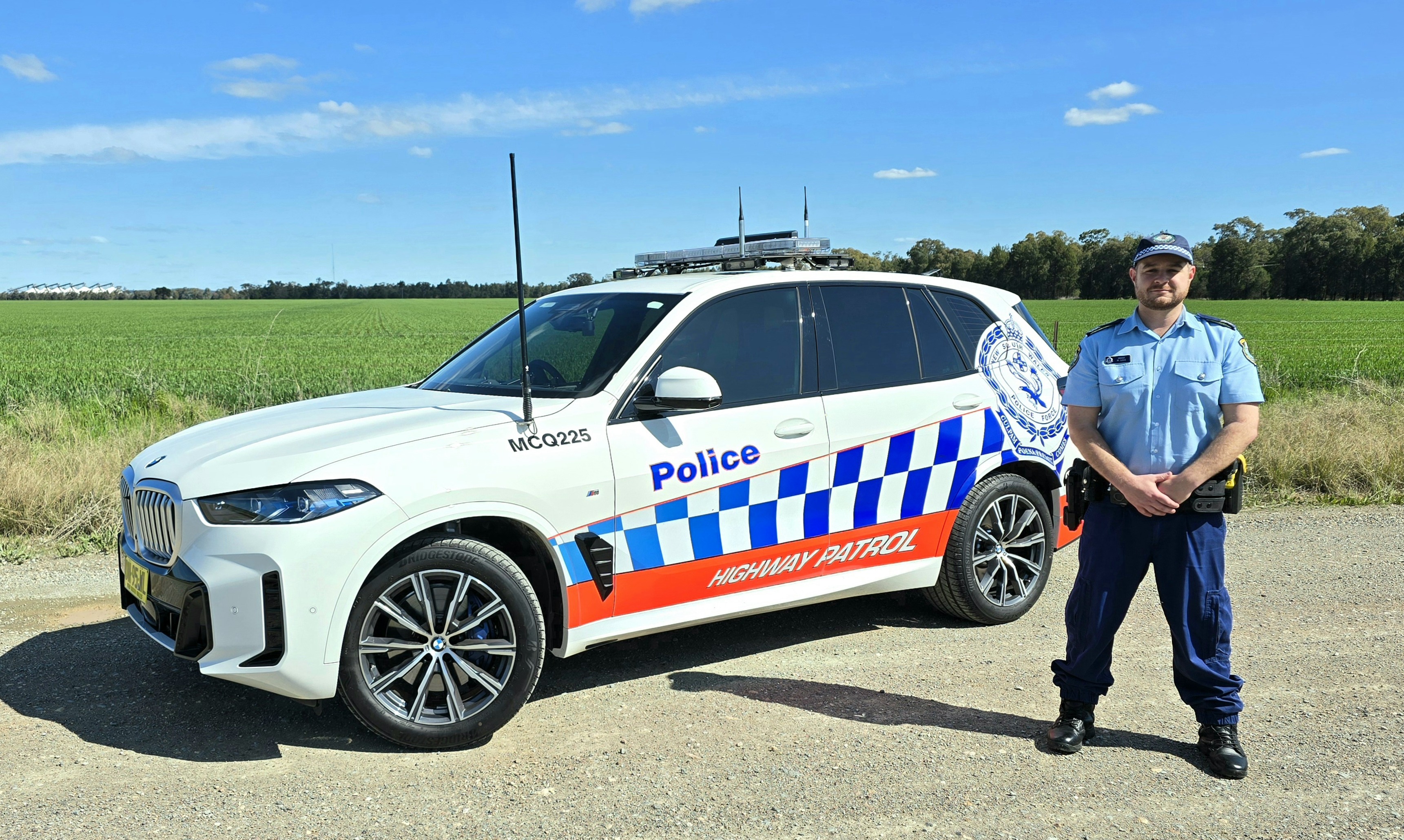 Police Officer standing in front of police vehicle